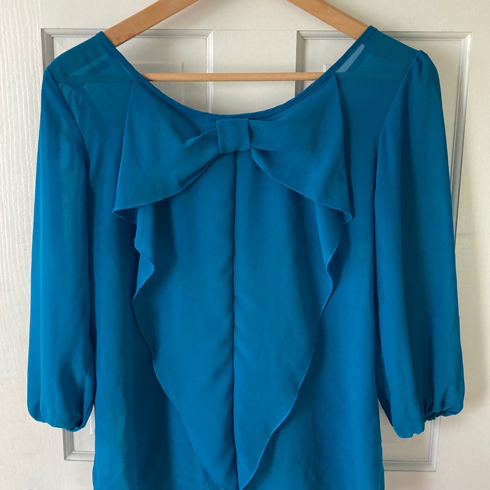 Sheer blouse with bow in back